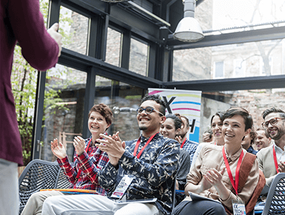 Group of people clapping and smiling