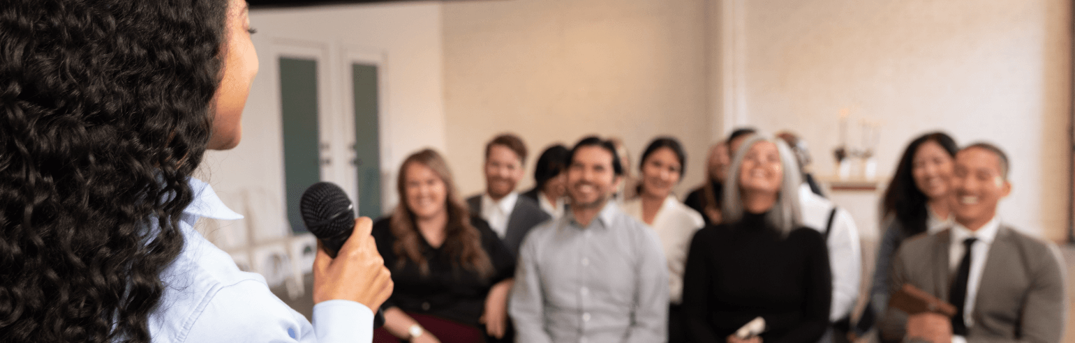 Woman speaking in front of an audience